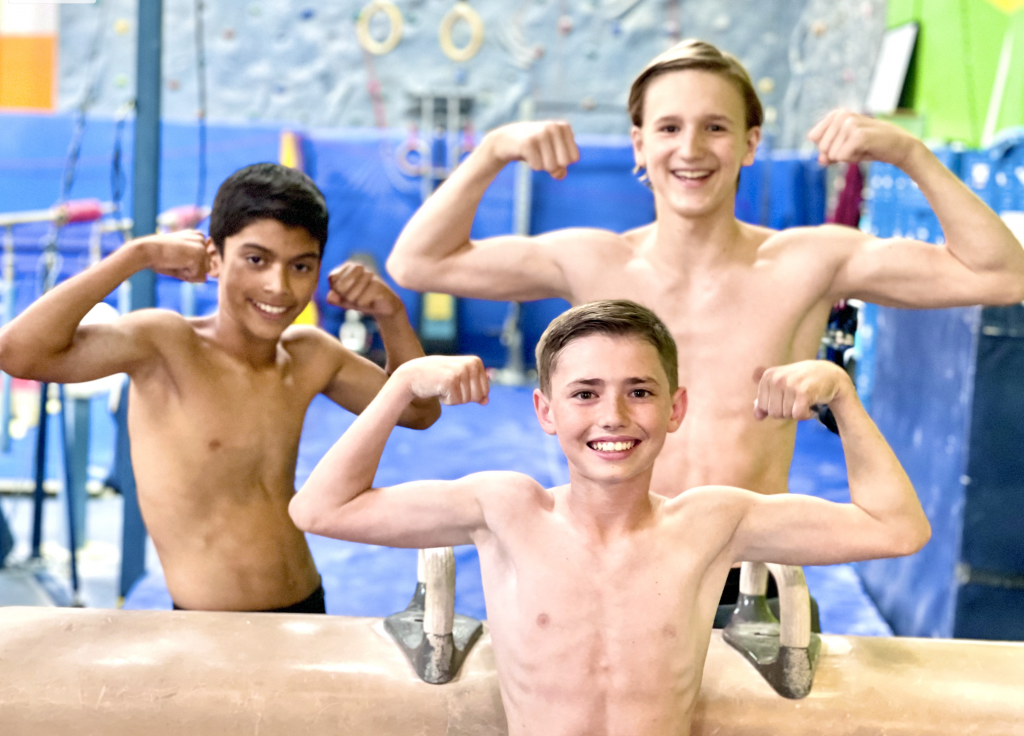 3 Male gymnasts flexing their muscles