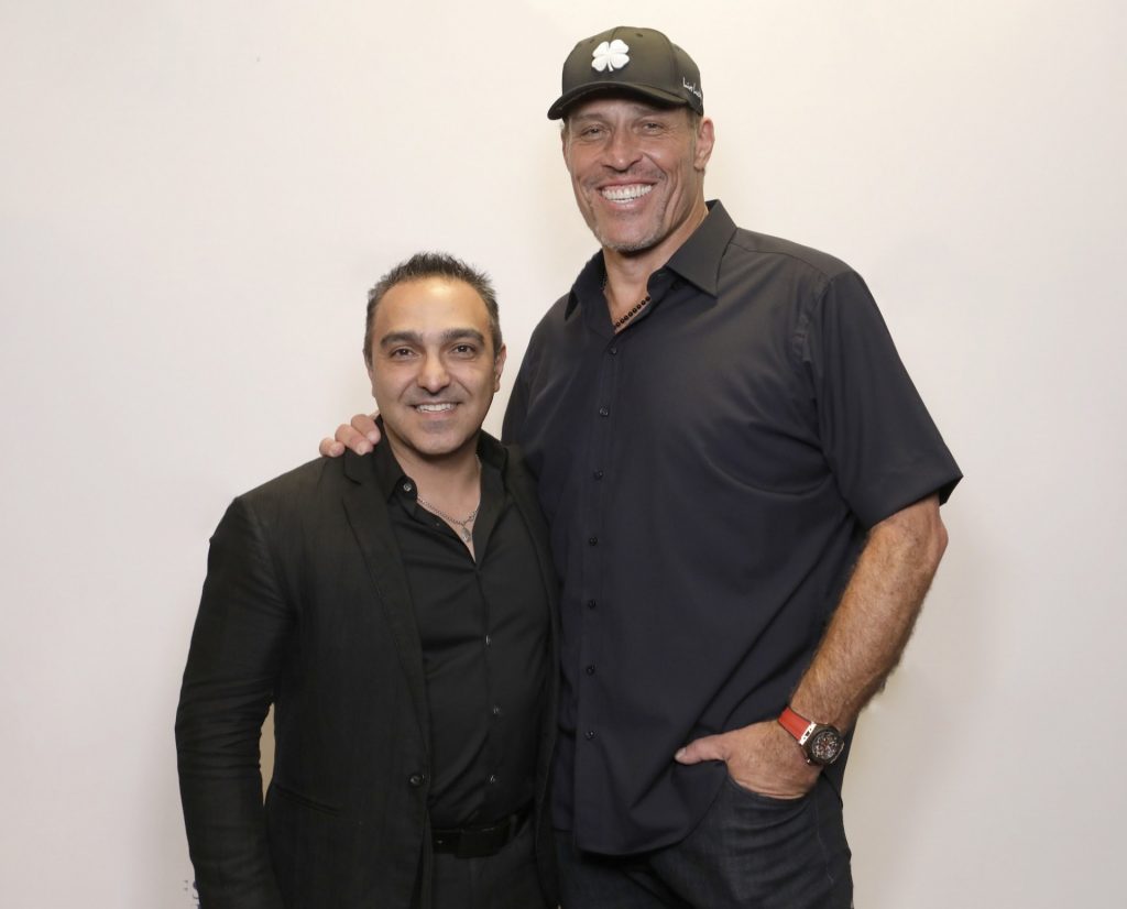 Freddy Behin with Tony Robbins posing for photo