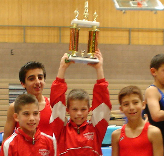 Boyd Team wearing red uniform holding up a trophy