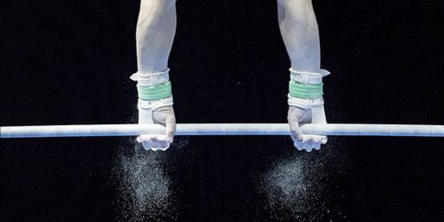 Background image of gymnast on highbar